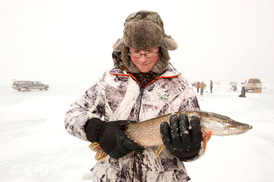Travis Patterson holds the northern pike he caught while ice fishing last winter.