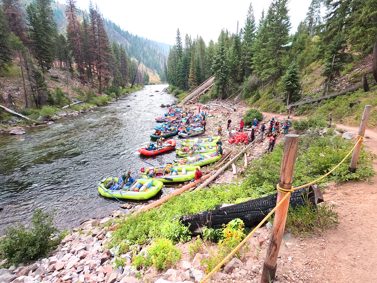 kayaks and rafts ready to launch on the river