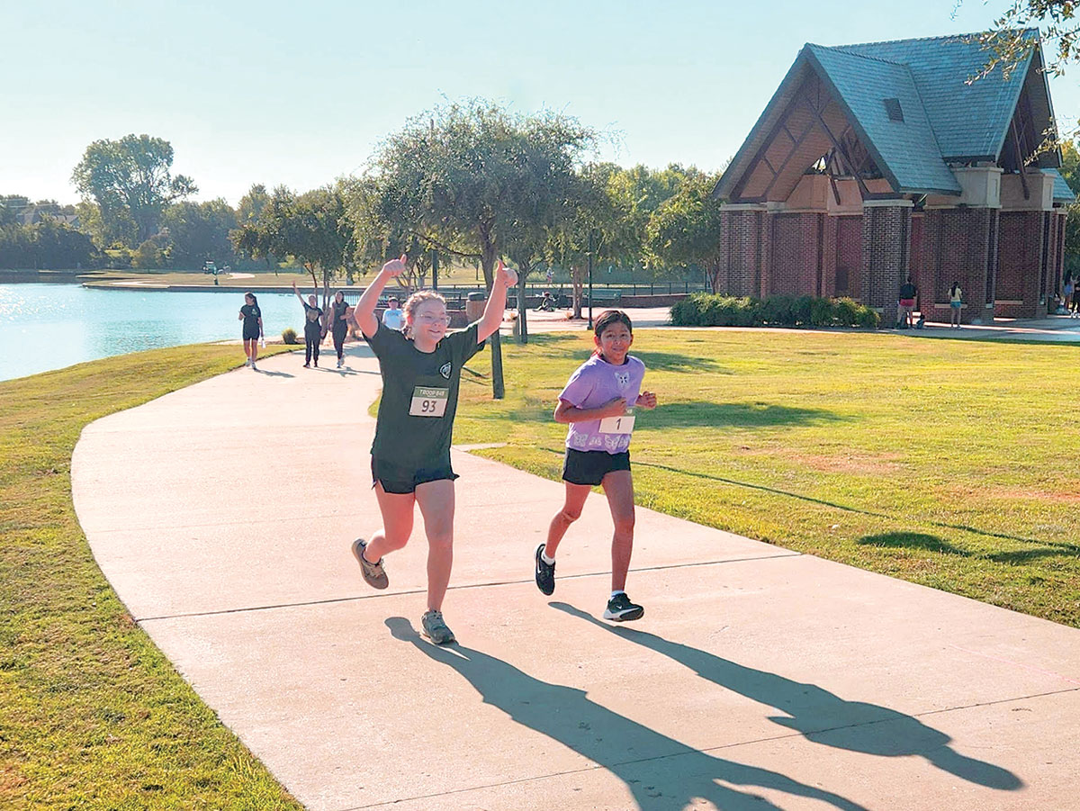 Scouts compete in the running portion of a triathlon race