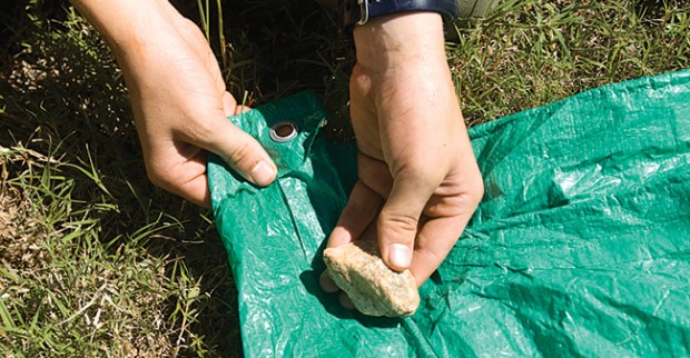 Step 2 Put rocks in each corner of tarp to build camp chair