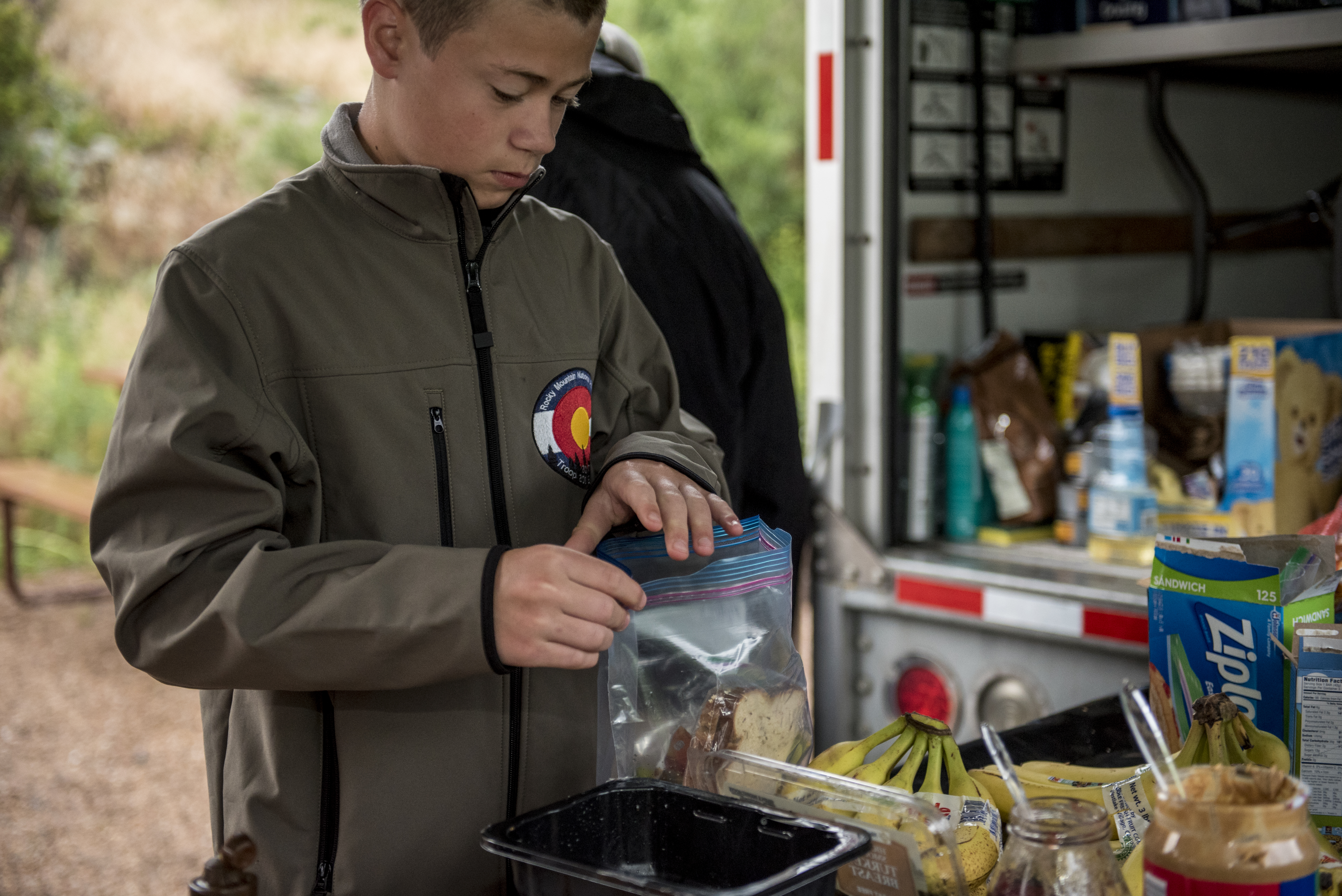 Scouts cook and eat  breakfast and get ready fot the days hike, in a campground in Estes Park during their adventure trip to Rocky Mountain National Park, Colorado