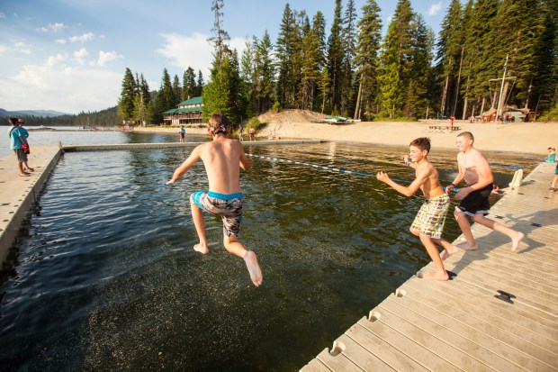 Boy Scouts leaping into Payette Lake at Camp Morrison's Waterfront facility.