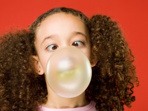 Little girl blows a big bubble