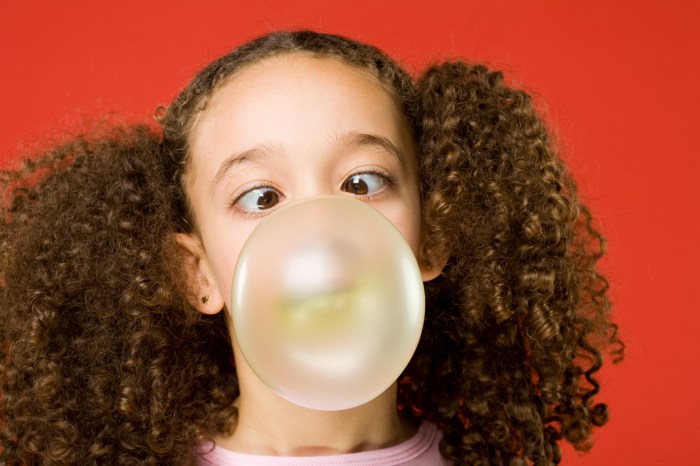 Little girl blows a big bubble