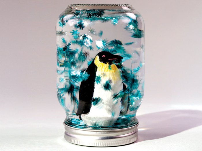 completed homemade snow globe with penguin