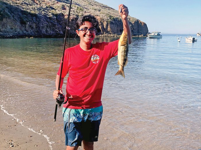 Aditya Khanna shows off the calico bass he caught.