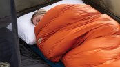 someone asleep in a sleeping bag