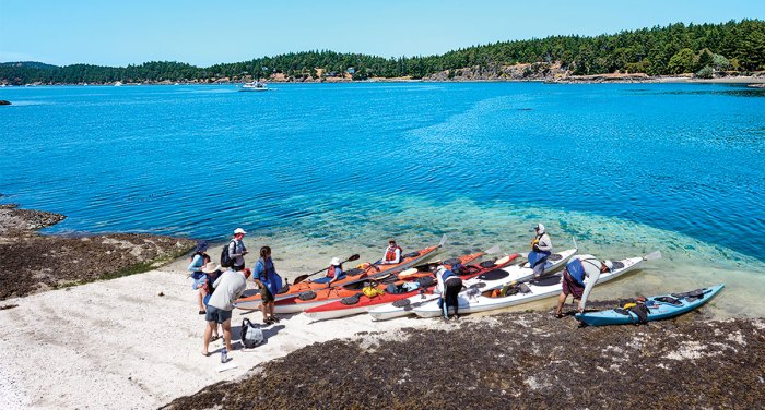 Scouts with kayaks on shore during lunch stop