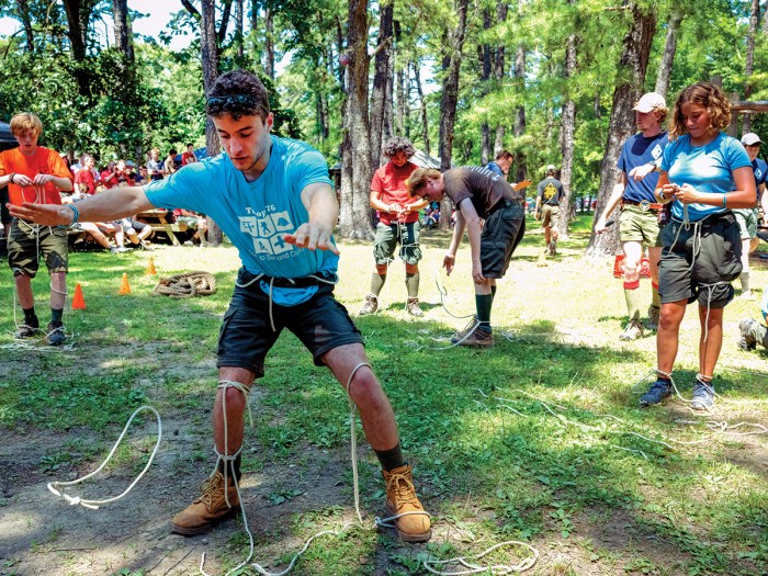 AJ Cooke completes a knot-tying challenge at summer camp