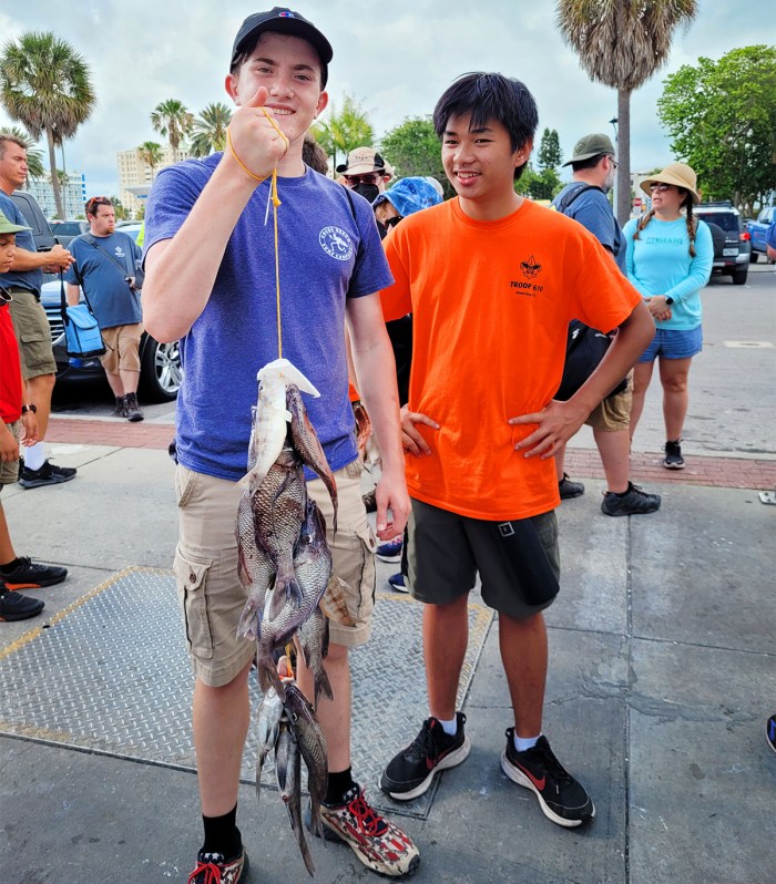 Scouts show off the fish caught during their troop’s offshore trip.