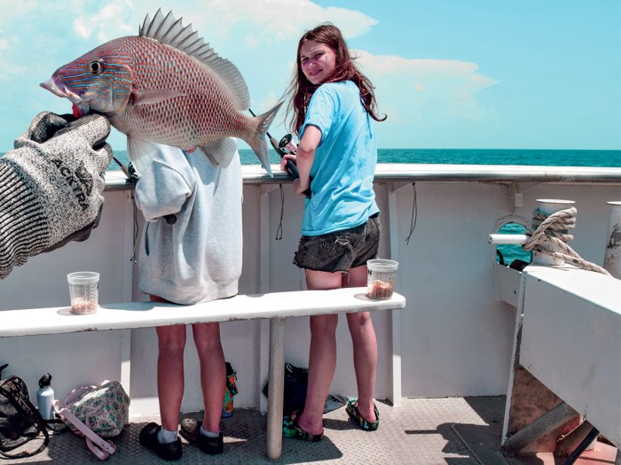 Grace Burden
looks back at a bluestriped grunt that was reeled in