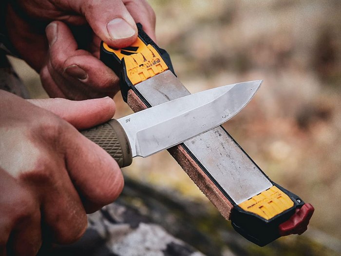 The Man Using Whetstone To Sharpening His Pocket Knife. Pocket