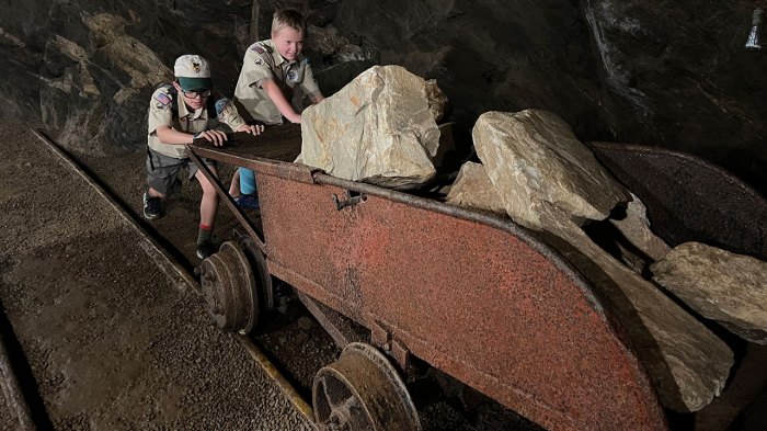Scouts pretend to push mining cart