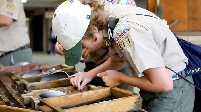 Scout pans for gold.