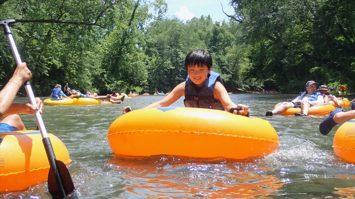 Scout tubing in river