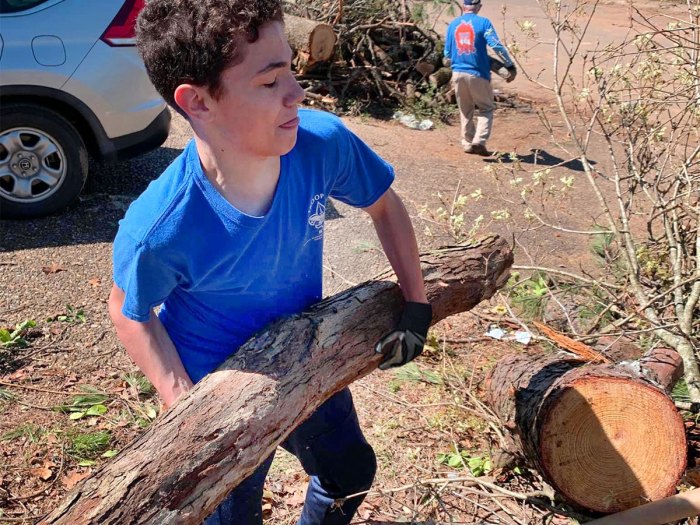 Scout removes a fallen log in Little Rock, Arkansas