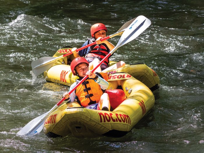 Two Scouts paddle the river