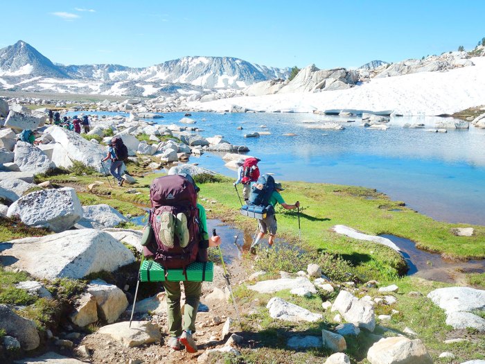 Scouts approach a lake in the Sierra Nevadas