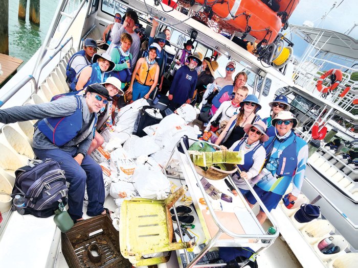 Scouts with debris cleaned from a waterway