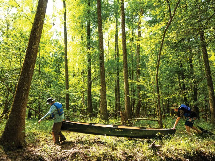 Scouts portage around an obstacle