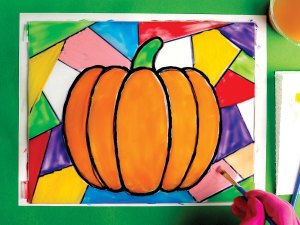 Painting color on the glass to make a faux stained glass pumpkin