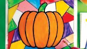 Painting color on the glass to make a faux stained glass pumpkin