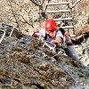 Reaching for an iron rung on a via ferrata in west virginia