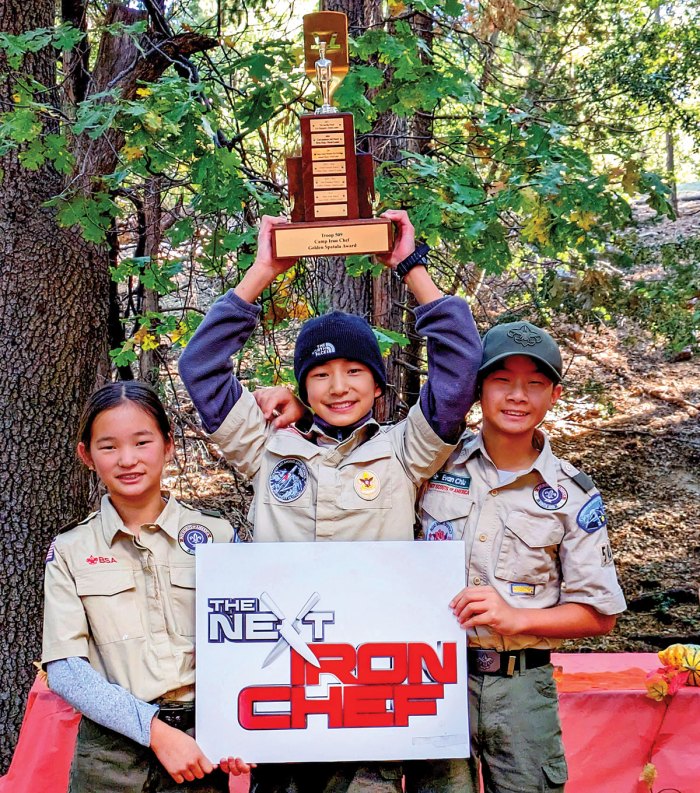 winning patrol holds up the trophy for best outdoor cooking