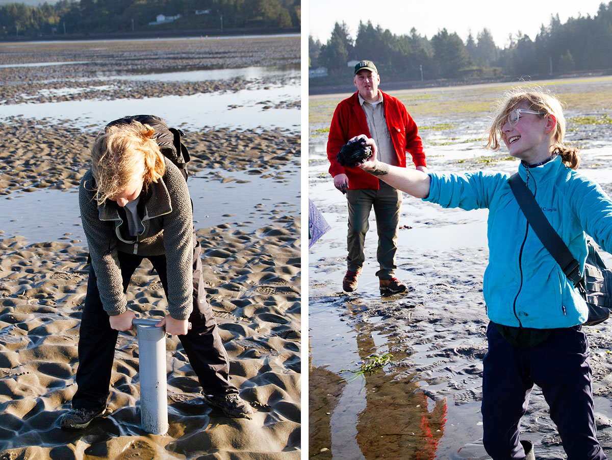 Scout holds up a mollusk she found while another Scout uses a clam gun to search for clams