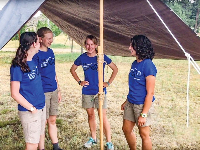 Scouts standing under a dining fly