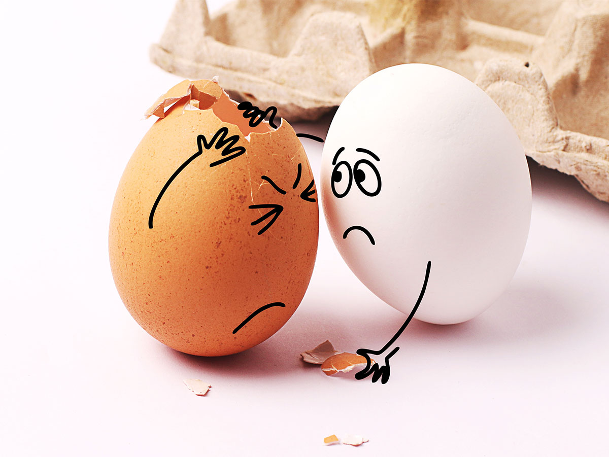 funny photo of two eggs with one comforting the other who has a cracked shell