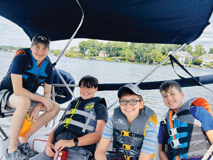 scouts smile onboard a small boat