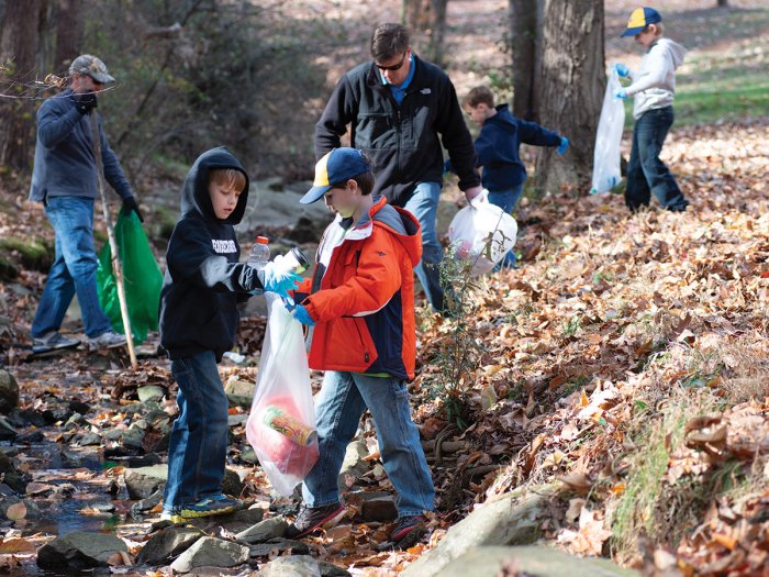 Cub Scouts cleanup up trash from a stream