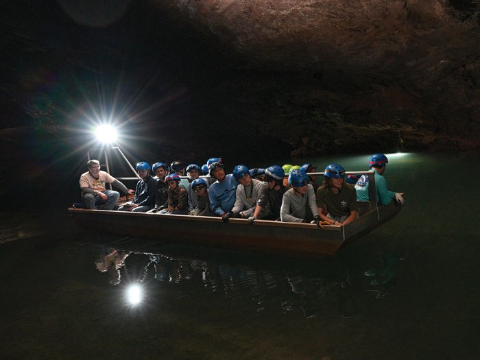 Scouts on a boat in an underground lake