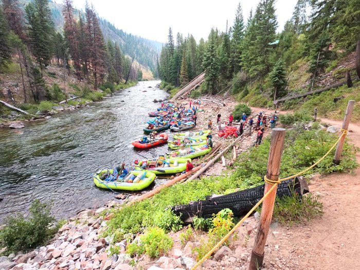 kayaks and rafts ready to launch on the river