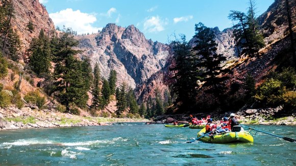 Troop 260 of San Jose, California, floats down the Salmon River flanked by rugged peaks